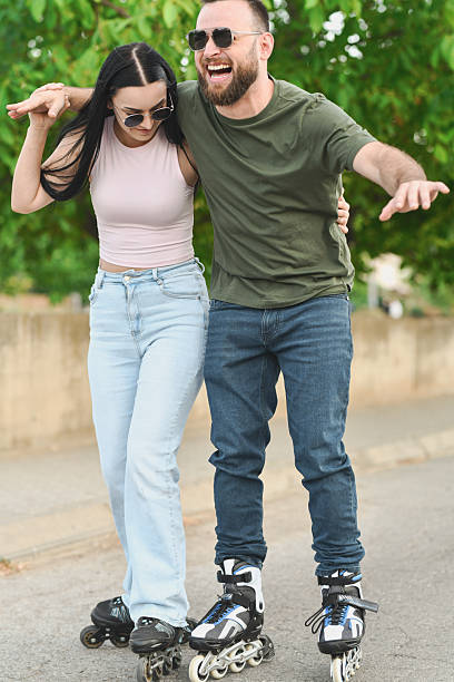 istock Female Holding Boyfriend While He is Trying Rollerblading for First Time 2225579606