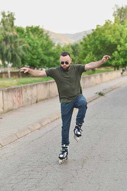 Relaxed Man Rollerblading Through Quiet Street Trying Out New Moves