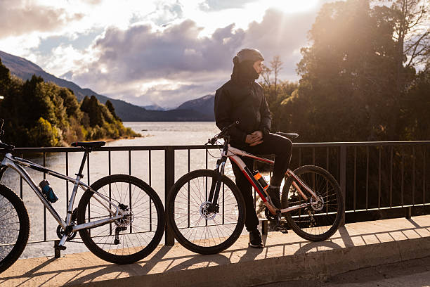 Young cyclist looking around during a break in Patagonia, Argentina