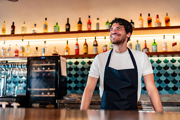 istock Young waiter contemplating at coffee shop 2225583416