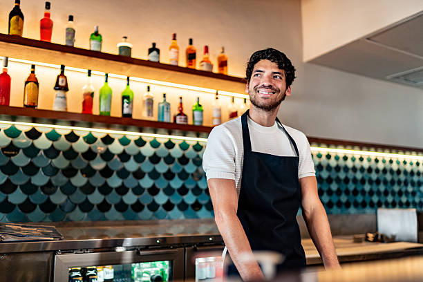 istock Young waiter contemplating at coffee shop 2225583417