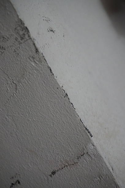 istock Abstract view of textured corner wall with cracks and natural lighting, highlighting raw surface detail and urban interior mood 2225583662