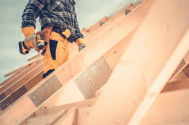 istock Construction Worker Using Power Tool on Roof During Daylight at a Building Site in a Residential Area 2225584424
