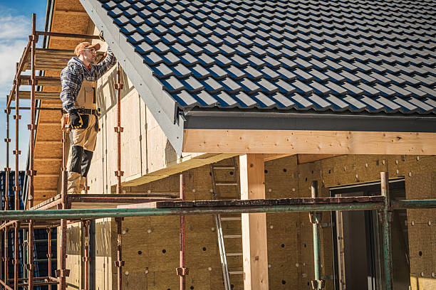 istock Construction Worker Installing Roof Tiles on New House Under Clear Blue Sky 2225584594