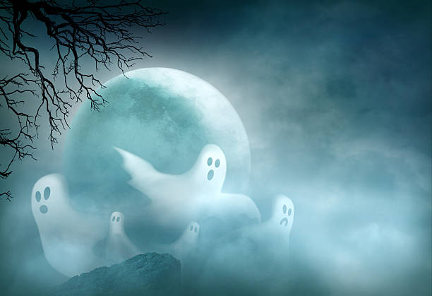 Several ghosts flying in front of a large rising full moon.  The gnarled branches of a bare tree are silhouetted by the moonlit sky.