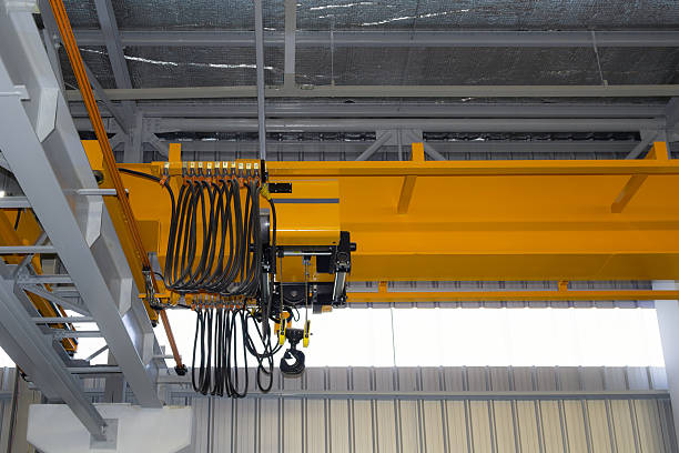 istock Overhead crane or lifting equipment inside factory or warehouse. 2225587752