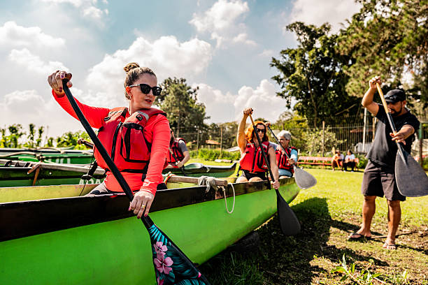 istock Instructor explaining how to row in a canoe for friends outdoors 2225589086