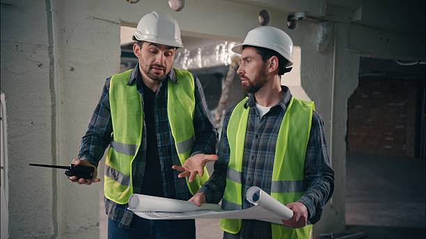istock Two contractors civil engineers discuss arguing Caucasian men builders males conflict problem architects workers talking blueprint paper disagreement guys teamwork building project plan construction 2225591452