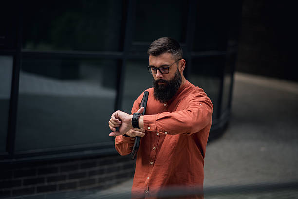Stylish Young Man On A Street Checking The Meeting Time