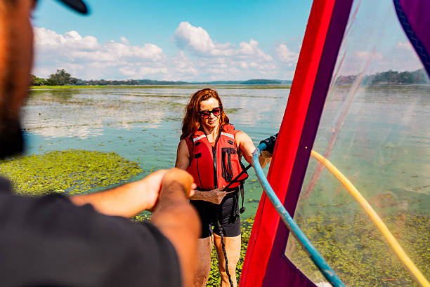 istock Mature woman learning to windsurf with an instructor in a lake 2225594666