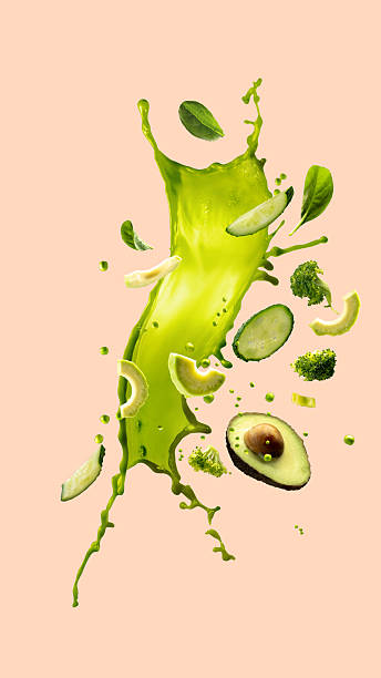 Hand made collage. Avocado and green vegetables in motion with vibrant green splash