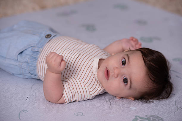 istock Adorable Baby Resting Calmly on Soft Play Mat. 2225595134