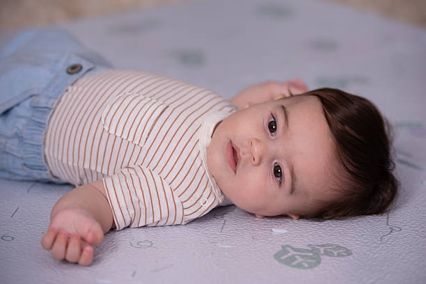 istock Thoughtful Baby Lying on Play Mat at Home. 2225595369