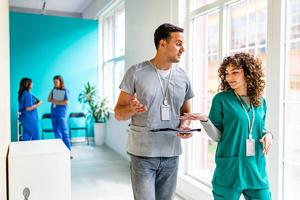 istock Healthcare professionals collaborate in a hospital corridor during a routine shift involving patient care and documentation 2225596898