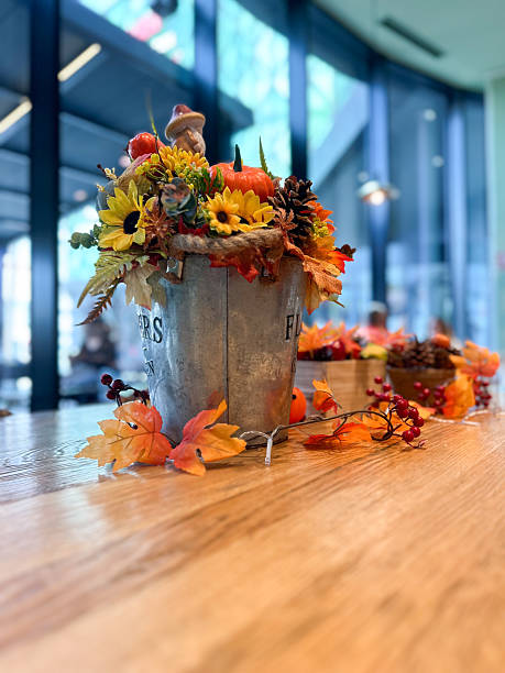 istock Festive autumn table arrangement with vibrant fall decorations and a miniature pumpkin. Warm tones and cozy ambiance evoke the spirit of the harvest season and Halloween celebrations 2225598307