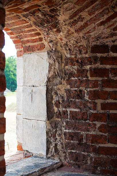 istock View through a historic arched window in a medieval brick fortress wall 2225598809