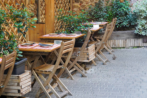 istock Charming Outdoor Restaurant Terrace with Tables and Chairs Ready for Dining 2225600026
