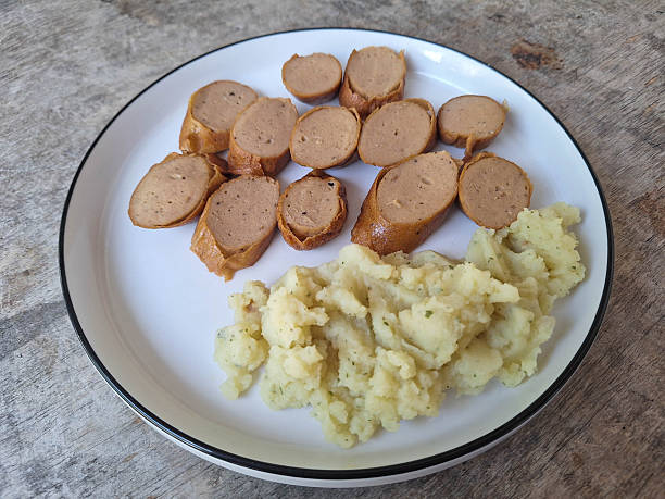 Serving of Fried Bratwurst Sausage with Mashed Potato on a Plate. Food Menu.
