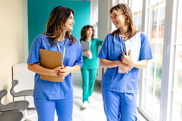 istock Healthcare professionals engage in conversation inside a hospital setting during a busy workday 2225602755