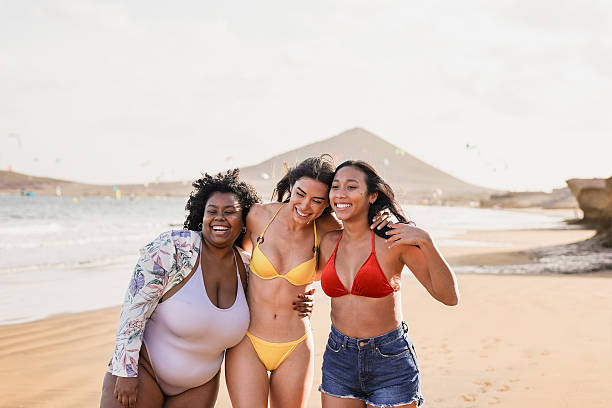 istock Young multiracial women with different bodies walking on the beach during summer vacation - Diverse latin girls having fun together outdoor 2225603634