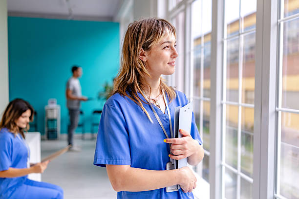 istock Healthcare professionals interact in a modern hospital setting while providing patient care and support 2225605034