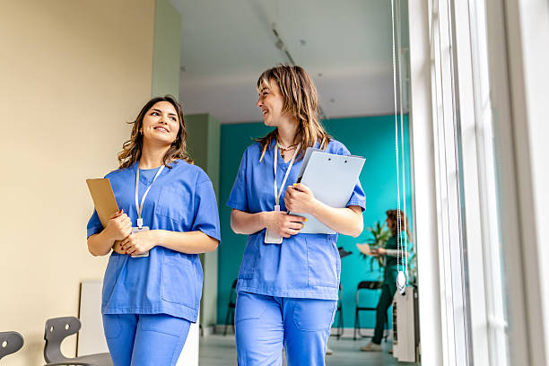 istock Healthcare workers collaborate in a hospital corridor while sharing insights and discussing patient care strategies 2225606481