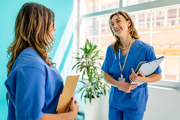 istock Healthcare workers engage in a discussion inside a hospital setting while providing patient care 2225606993