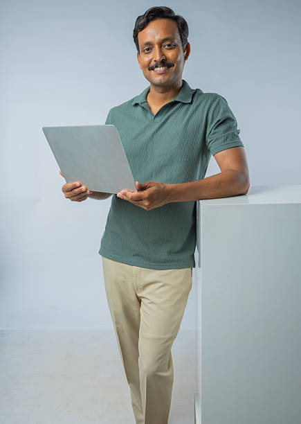 istock Man with laptop against white background 2225608598