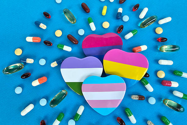 istock Colorful heart shaped containers surrounded by various pills and capsules on a vibrant blue surface concept 2225609172