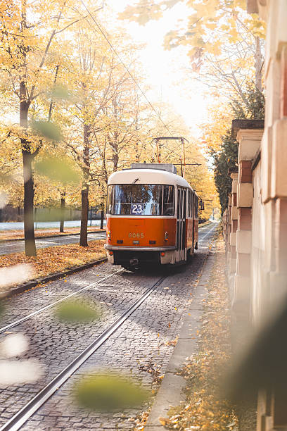 istock Vintage trams glide down a tree lined avenue ablaze with autumn hues in Prague, blending historic charm with nostalgic flair in the city iconic public transport network. 2225610284