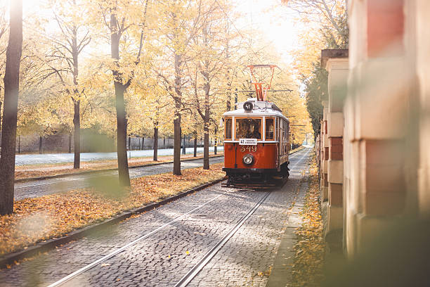 istock Vintage trams glide down a tree lined avenue ablaze with autumn hues in Prague, blending historic charm with nostalgic flair in the city iconic public transport network. 2225610297
