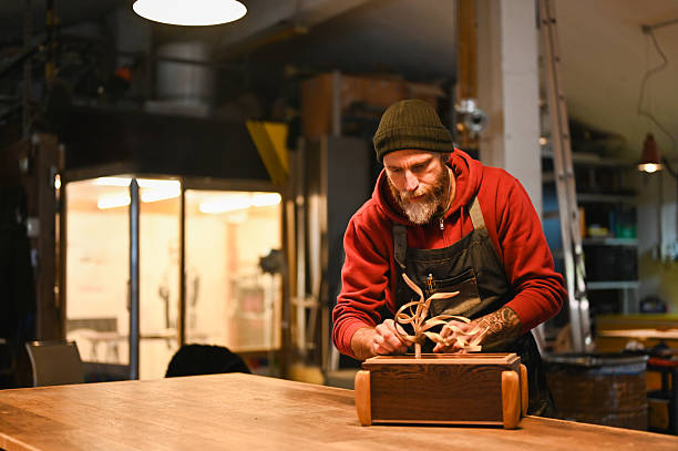 Carpenter creating wooden decoration in workshop