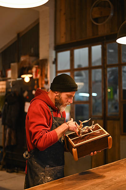Carpenter working on wooden box in workshop