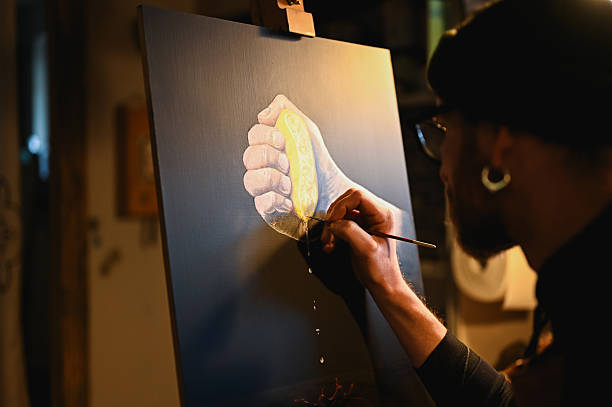istock Artist painting a squeezed lemon on canvas in art studio 2225613416