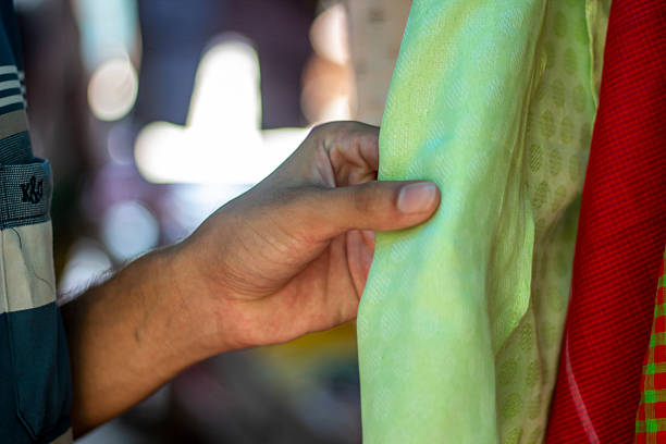 a young man holding a cloth on the shop
