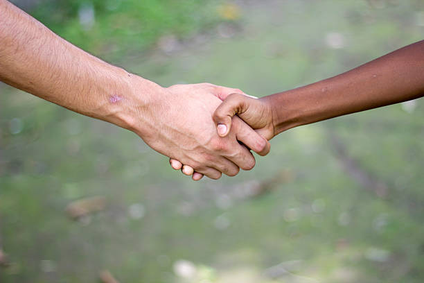 Handshake of senior people man and woman on a white background. Relationships between older people, support and help in age