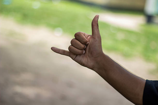 istock A man pointing two fingers of his hand forward and green background 2225620110