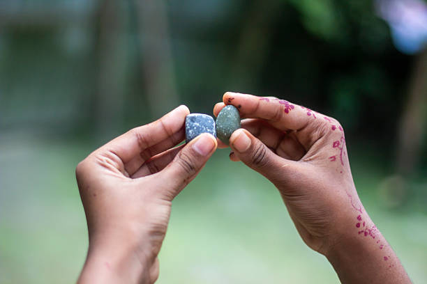 istock A human hand holding two stone and a background blur 2225620312