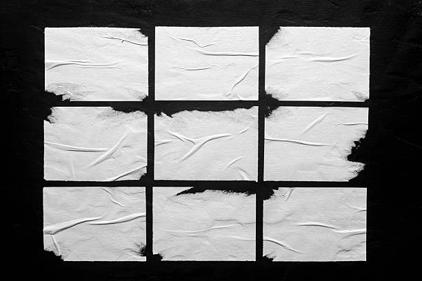 istock Several white posters with folds on a black background. 2225621483