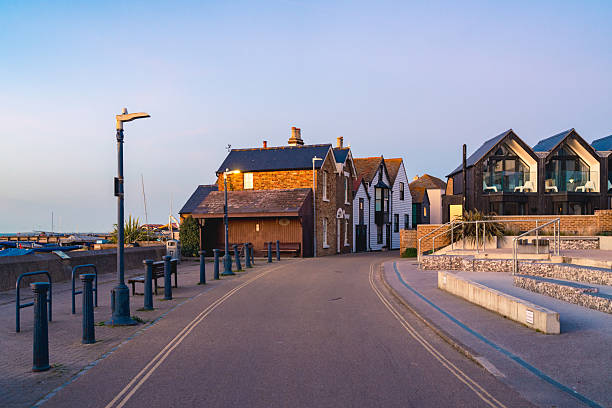Empty harbour street in whitstable, england, bathed in the warm glow of sunrise