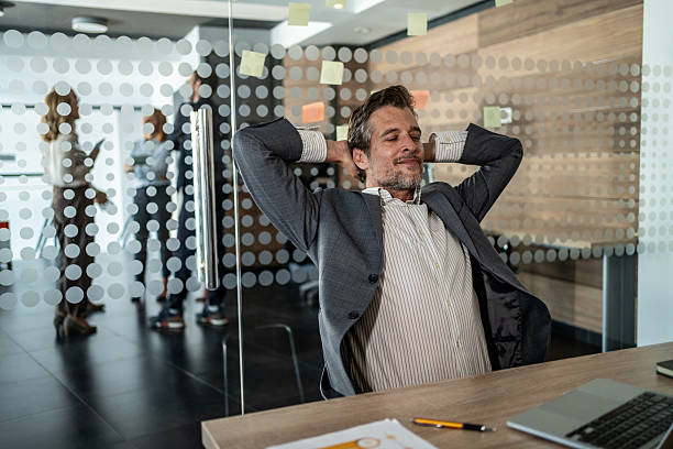 istock Businessman relaxing at his desk in modern office 2225621786