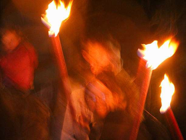 Traditional event in Cranleigh, Surrey.  Guy Fawkes Bonfire night, a fire torch parade and bonfire event, November 4th 2024