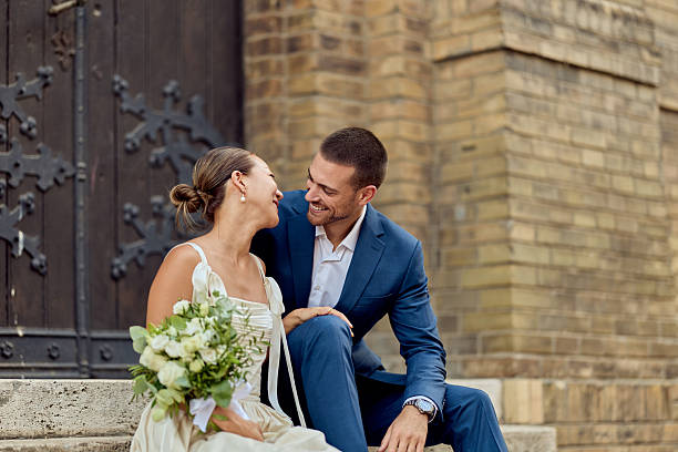 Elegant Wedding Couple Smiling on Steps of Historic Rustic Building