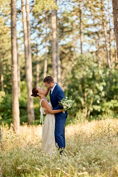 istock Romantic Wedding Couple Embracing Outdoors in Forested Park Setting 2225623102
