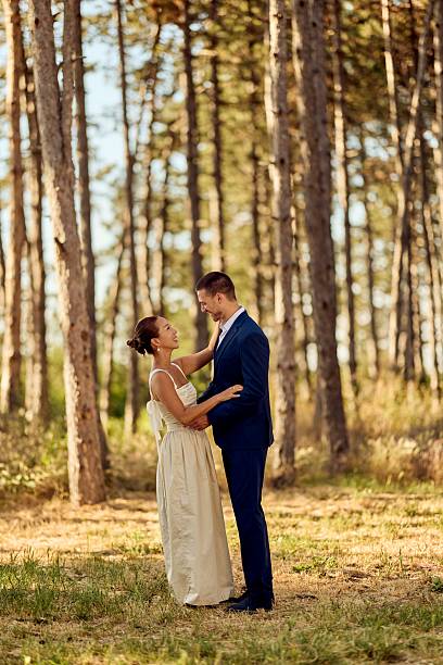 istock Romantic Couple Celebrating Wedding Day in Beautiful Sunlit Forest Setting 2225623104