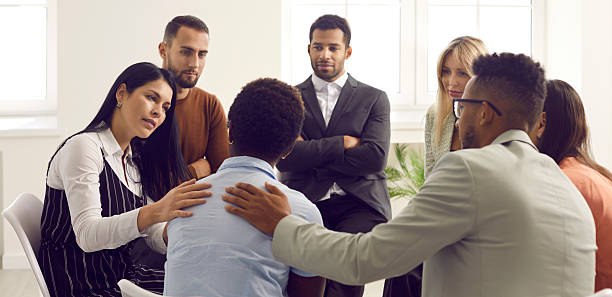 istock Caring people support stressed group member at counseling 2225623264