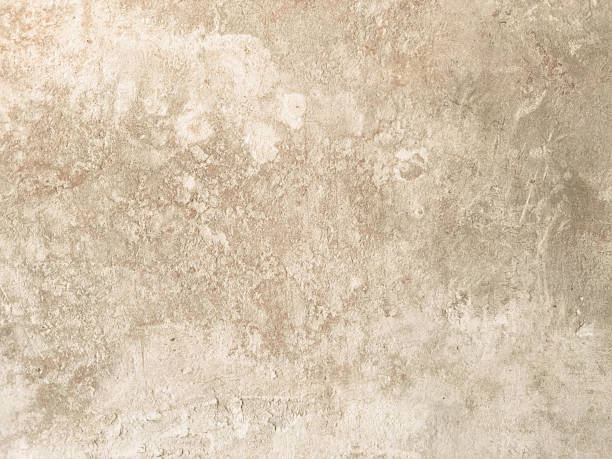 istock Distressed beige texture with light and dark variations resembling aged concrete or plaster, ideal for backgrounds, rustic designs, or material samples 2225626990