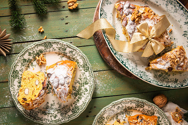 istock Portuguese Bolo Rainha slice: sugared nuts on festive bread, on a green table with Christmas ornaments. A traditional dessert for Christmas, New Year's & Epiphany. Top view 2225627165