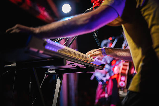 Close-up of a man's hand playing an electric piano. Stage performance