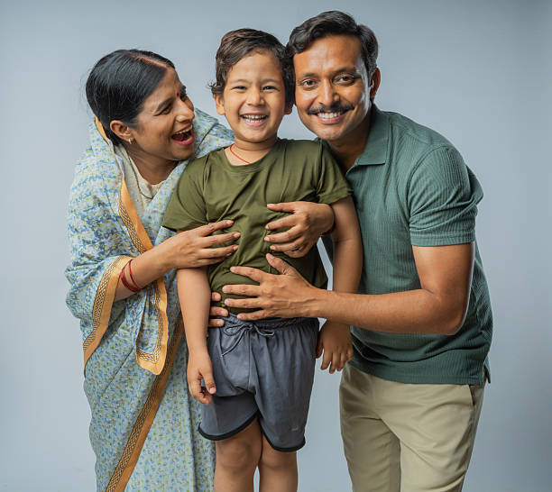 istock Loving parents with cute son standing on white background 2225630254